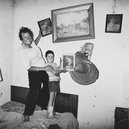 Diamond digger and son standing on bed, Western Transvaal, 1987