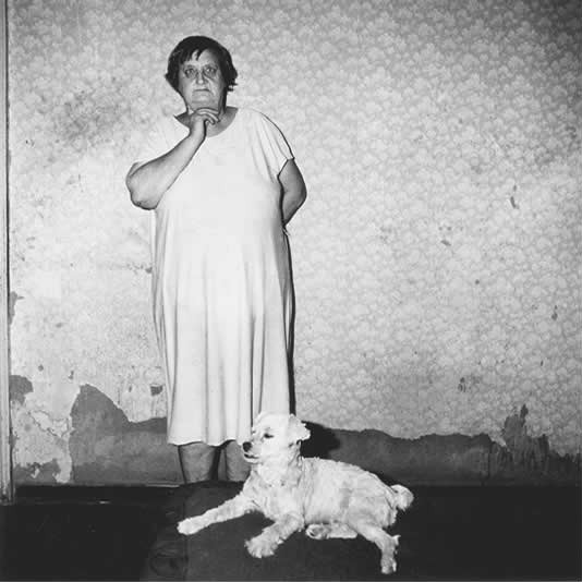 Mrs J J Joubert and dog, Dinky, in bedroom, Central Cape, 1990